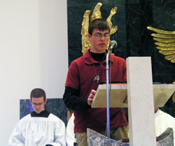 Peter Jansen serves as a lector at the archdiocesan youth Mass held on April 20 at the National Shrine of Our Lady of Czestochowa in Doylestown, Pa. Also pictured is altar server Michael Kubancsek. Both teenagers are members of Our Lady of the Greenwood Parish in Greenwood and are considering vocations to the priesthood. (Photo by Bryce Bennett) 