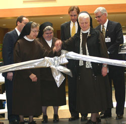 Several St. Francis Hospital officials cut a ribbon on April 16 to officially open the expanded St. Francis Hospital-Mooresville in Mooresville. They are, from left, Keith Jewell, chief operating officer of St. Francis Hospital and Health Centers; Franciscan Sisters of Perpetual Adoration Jane Marie Klein, chairperson of the Sisters of St. Francis Health Services Inc. board of trustees, and Angela Mellady, her order’s provincial superior; Dr. John Meding, medical staff president of St. Francis Hospital-Mooresville; Franciscan Sister of Perpetual Adoration Mediatrix Nies, the order’s general superior; and Robert Brody, president and chief executive officer of St. Francis Hospital and Health Centers in Beech Grove, Indianapolis and Mooresville. (Submitted photo ) 