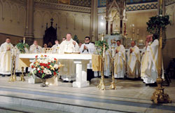 Archbishop Daniel M. Buechlein celebrates Mass on May 2 at St. John the Evangelist Church in downtown Indianapolis for members of the “Run for Vocations” team that participated in the One America 500 Festival Mini-Marathon on May 3. (Photo by Sean Gallagher)