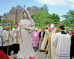 Archbishop Pietro Sambi, apostolic nuncio to the United States, blesses a statue of St. Theodora Guérin, Indiana’s first saint, on May 10 in Mary’s Garden outside the Basilica of the National Shrine of the Immaculate Conception in Washington. Members of the Sisters of Providence of Saint Mary-of-the-Woods, the religious community founded by St. Theodora in 1840, stand behind the statue. (Submitted photo/Sisters of Providence)