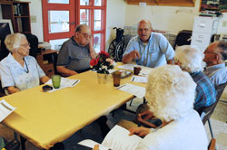 Deacon candidate Lawrence French, third from left, leads a Bible study on June 5 at Buckeye Village, a senior citizens apartment complex in Osgood. The participants in the Bible study are a mixed group of Catholics and non-Catholic Christians. (Photo by Sean Gallagher)	