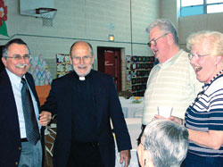 Members of St. Simon the Apostle Parish in Indianapolis visit with their former pastor, Msgr. Harold Knueven, currently administrator of St. Mary Parish in Greensburg, on May 18 at the Batesville Deanery parish during a celebration of the 50th anniversary of his priestly ordination. From left are St. Simon parishioners Tom Thibo and Charlie and Peggy McIntosh. (Submitted photo) 