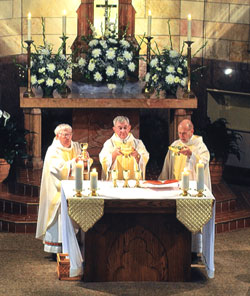 Marking his 50th year as a priest, Father Harold Ripperger, center, concelebrates Mass with his brother, Father William Ripperger, left, and Msgr. Harold Knueven, right. The anniversary Mass was celebrated on May 17 at St. Mary Church in Lanesville. Father Harold Ripperger is the pastor of St. Mary Parish in Lanesville. (Submitted photo) 