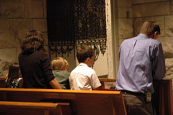 Natural Family Planning teachers Ann and Mike Green, members of St. Alphonsus Parish in Zionsville, Ind., in the Lafayette Diocese, kneel in prayer with their children, Mary, John Paul and Jimmy, during the Mass for chastity on July 25 in the chapel of St. Luke the Evangelist Church in Indianapolis. The liturgy was sponsored by the Archdiocese of Indianapolis, Diocese of Lafayette and Couple to Couple League of Greater Indianapolis. (Photo by Mary Ann Wyand) 