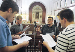 Seminarian Jerry Byrd, second from right, leads a choir comprised of fellow seminarians during a Mass on Aug. 13 at St. Patrick Church in Indianapolis. The Mass took place during a seminarian pilgrimage to six of the oldest churches in Indianapolis. Singing in the choir are, from left, seminarians Gregory Lorenz, Andrew Proctor, Daniel Bedel and Benjamin Syberg. (Photo by Sean Gallagher) 