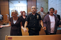 Indianapolis Metropolitan Police Department Lt. Vincent Cascella, center, prays the Lord’s Prayer with other participants during the sixth annual archdiocesan Blue Mass that paid tribute to public servants on Sept. 11 at the Calvary Cemetery Mausoleum Chapel in Indianapolis. He is a member of St. Roch Parish in Indianapolis, and represented the IMPD’s Southeast District at the liturgy. (Photo by Mary Ann Wyand) 