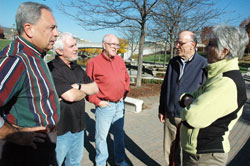 Father John Mark Ettensohn, left, Brother Pat McGee and Brother Paul Daly, all members of the Missionary Oblates of Mary Immaculate, chat on Nov. 5 along the Canal Walk in downtown Indianapolis with Fred and Tana Moses, who live along the canal. In what they call “Mission with Secularity,” the Oblates seek to reach out through ordinary conversations and relationships to those who have a secularist worldview and feel no need for God. (Photo by Sean Gallagher) 