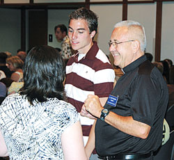 Father Jeff Godecker, right, shares a laugh with Butler University students before a Mass to celebrate the beginning of the school year on campus. As the chaplain of the Butler Catholic community, Father Godecker is a daily presence at the Indianapolis college, reaching out to the Catholic students there and helping them make the Catholic faith their own. (Submitted photo) 