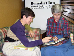 Benedictine Sister Sheila Marie Fitzpatrick, left, a member of Our Lady of Grace Monastery in Beech Grove, talks with Benedictine Sister Carol Falkner, prioress, about scheduling a meeting at the Benedict Inn, a retreat and conference center operated by the monastic community. (Submitted photo) 