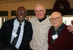 In December of 2008, 15 people who became friends at Cathedral High School made a bus trip for a reunion with the Holy Cross brothers who taught at the school. Here, former Cathedral coach Tom O’Brien poses between Holy Cross Brother Roy Smith, left, and Holy Cross Brother Roland Driscoll. Brother Roy played for Coach O’Brien. (Submitted photo) 