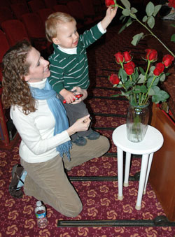 St. John the Evangelist parishioner Megan Certo of Indianapolis helps her son, Peter, place a rose in a vase in memory of the more than 50 million unborn babies who have died in abortion since it was legalized by the U.S. Supreme Court on Jan. 22, 1973. David and Megan Certo are expecting their second child in June. (Photo by Mary Ann Wyand) 