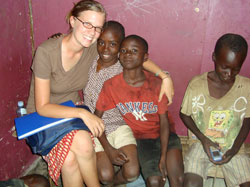 During her volunteer efforts in the slums of Kampala, the largest city in Uganda, Jenna Knapp taught literacy and provided basic health care for children who lived in the streets. Left, the University of Notre Dame student from Indianapolis poses with two boys she met during her volunteer work. Right, she hugs a child she met in Uganda during 2008, the year when she split her time between studying and volunteering in that African country and in El Salvador. Both experiences solidified her belief that she wants to commit her life to service to others at home and around the world. (Submitted photo) 