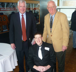 Gavin Provost, center, is pictured with Patrick McCaskey, co-owner of the Chicago Bears, left, and Dick Dornbos, who serves on Sports Faith International’s (SFI) advisory board. Provost received the Spirit of Saint Paul Award at Halas Hall on Feb. 21, and was inducted into the SFI High School Hall of Fame. (Photo by Karen Clifford)