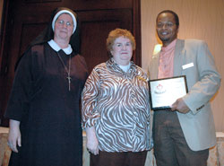 Servants of the Gospel of Life Sister Diane Carollo, director of the archdiocesan Office for Pro-Life Ministry, and Eileen Hartman, director the Gabriel Project of Indiana, pose with Eric Slaughter. Slaughter, a member of Our Lady of the Most Holy Rosary Parish in Indianapolis, received a Pro Vita Award on March 7 for his pro-life work in the archdiocese. (Photo by Sean Gallagher) 