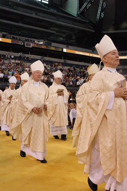Cardinal Francis E. George of Chicago confirms Alisha Webber, a member of Holy Family Parish in Oldenburg, during the May 3 Mass at Lucas Oil Stadium in Indianapolis that celebrated the 175th anniversary of the Archdiocese of Indianapolis. (Photo by Sean Gallagher) 