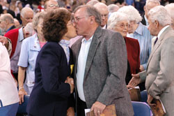 James and Pauline Petroviak of Lawrenceburg share a kiss for the sign of peace during the archdiocese’s 175th anniversary Mass on May 3 at Lucas Oil Stadium in Indianapolis. They are members of St. Teresa Benedicta of the Cross Parish in Bright. Nearly 200 couples married for 50 years or more received a nuptial blessing from Archbishop Daniel M. Buechlein during the historic liturgy. (Photo by Mary Ann Wyand) 