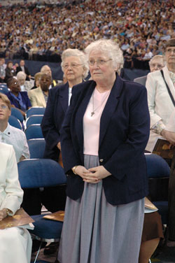 Benedictine Sister Mildred Wannemuehler, left, and Franciscan Sister Jean Marie Cleveland stand during the 175th anniversary Mass at Lucas Oil Stadium in Indianapolis on May 3 after Communion when religious jubilarians were recognized and blessed. This year, Sister Mildred is celebrating the 60th anniversary of her profession of vows and Sister Jean Marie is marking the 50th anniversary of her entrance into religious life. (Photo by Sean Gallagher) 