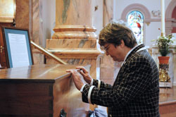 St. Joseph Sister Helen Prejean of New Orleans prays before the remains of St. Theodora Guérin on April 13 at the Church of the Immaculate Conception at Saint Mary-of-the-Woods. Actress Susan Sarandon earned an Academy Award for her portrayal of Sister Helen in the 1996 movie version of her book, Dead Man Walking. The play by that name is now offered without charge to student groups to present on stage as an educational program. (Photo by Mary Ann Wyand) 
