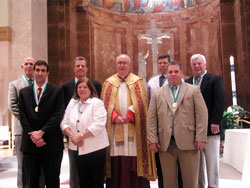 St. John Bosco Award winners from Indianapolis pose for a photograph with Msgr. Joseph F. Schaedel, vicar general, during the Catholic Youth Organization awards ceremony on May 6 at SS. Peter and Paul Cathedral in Indianapolis. They are, from left, Dr. Mark Bohnert of Nativity of Our Lord Jesus Christ Parish, Dr. James Rea of St. Pius X Parish, Jeff Taylor of St. Jude Parish, Kathy Caito of St. Lawrence Parish, Dave Goddard of St. Michael the Archangel Parish, Jerry Deery of Our Lady of Lourdes Parish and Bill Roberts of St. Luke the Evangelist Parish. (Photo by John Shaughnessy) 