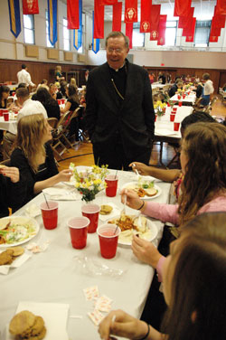 Archbishop Daniel M. Buechlein talks with “A Promise to Keep” chastity peer mentors during the annual recognition luncheon on April 23 at the Archbishop O’Meara Catholic Center in Indianapolis. (Photo by Mary Ann Wyand) 