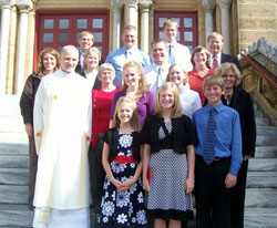 Deacon John Hollowell poses at left in the second row with his family and other relatives on Oct. 25, 2008, on the steps of the Archabbey Church of Our Lady of Einseideln in St. Meinrad. Posing with him are, first row, from left, Maria, Laura and Nathan Hollowell; second row, from left, grandmother Jeanette, Emily, Sara and mother Diane Hollowell; third row, from left, sister-in-law Kari, Melissa and Danny Hollowell, and aunt and godmother Cindy Huff; and fourth row, from left, Tony, Aaron, Matt and father Joseph Hollowell. (Submitted photo) 