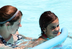 Catholic Youth Organization camp counselor Vicky Hathaway and 10-year-old Marissa Pate smile as they play in the pool at CYO Camp Rancho Framasa in Brown County. Marissa is one of about 35 children with disabilities who will enjoy a camping experience at Camp Rancho Framasa this summer thanks to the inclusive approach of the CYO Camp. (Submitted photo/Kent Hughes)