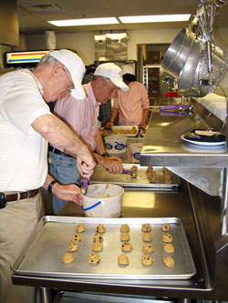 Bill Clear, left, and Bill Pfiefer, both members of St. Monica Parish, help bake 413 dozen cookies on April 25 at the parish for Kairos Prison Ministries retreats that happened this spring at the Plainfield Correctional Facility in Plainfield and Rockville Correctional Facility in Rocville. (Submitted photo)