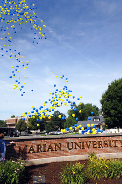 Blue and yellow balloons are released on June 27 on the campus of Marian College in Indianapolis to celebrate its name change from Marian College to Marian University. Daniel Elsener, the school’s president, recently announced that it had received a $6 million gift from a former trustee, a record individual gift for Marian. (Photo courtesy of Marian University)