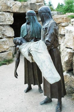 This bronze tableau depicts Christ’s body being carried to an empty tomb by Joseph of Arimathea and Nicodemus in one of the dramatic Stations of the Cross at the “Shrine of Christ’s Passion” in St. John, Ind. (Photo by Mary Ann Wyand)