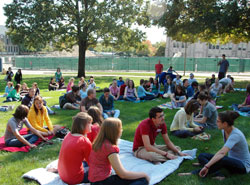 College students sit outside Butler University in Indianapolis to attend “Mass on the Grass.” Catholics at Butler Univeristy have no building to call their own, but Mass is offered most Sundays at 1:30 p.m. at the Johnson Room in Robertson Hall. (Submitted photo)