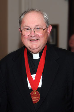 Msgr. Frederick Easton, archdiocesan vicar judicial, poses on Aug. 4 at Saint Meinrad School of Theology in St. Meinrad while wearing the Distinguished Alumnus Award he received from the seminary during its 81st annual alumni reunion. (Photo courtesy of Saint Meinrad Archabbey)