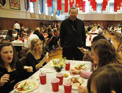 Archbishop Daniel M. Buechlein talks with Catholic high school students during a luncheon in April honoring student leaders in the A Promise to Keep: God’s Gift of Human Sexuality program. In the archdiocesan program, Catholic high school students pledge to follow a life of chastity and share that message with students in the junior-high age group in Catholic grade schools. The archdiocese is expanding its chastity education program to involve parents and educators. (File photo by Mary Ann Wyand) 