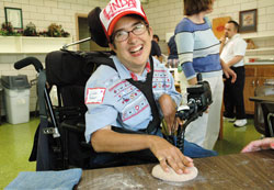 SPRED participant and St. Monica parishioner Linda Palmer of Indianapolis smiles as she kneads bread dough on Aug. 29 during the archdiocesan Special Religious Development retreat at the Benedict Inn Retreat and Conference Center in Beech Grove. (Photo by Mary Ann Wyand) 