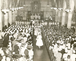 Girls process out of Our Lady of Lourdes Church in May 1955 at the conclusion of a May crowning ceremony in the parish situated in the heart of Irvington, a historic neighborhood on Indianapolis’ east side. (Submitted photo) 