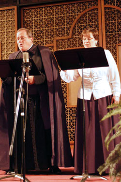 Priestly Fraternity of St. Peter Father Michael Magiera and high school teacher Ann Lewis perform together during a benefit for Lumen Christi Catholic School in Indianapolis on Oct. 7. (Submitted photo)