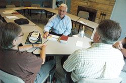 Deacon Steve Hodges, second from left, speaks with two members of the Indianapolis chapter of Courage, an apostolate that gives support to people who have same-sex attractions, but want to live chaste lives according to the Church’s teachings on chastity and homosexuality. (Photo by Sean Gallagher)