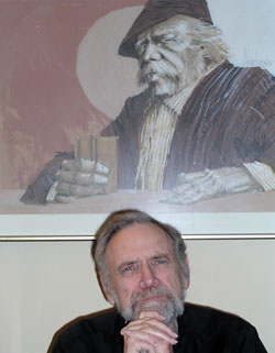 The large picture behind Father Lawrence Voelker’s desk reminds him of the strength of people who have lived a long life, people who “do what needs to be done.” In 43 years as a priest, including serving as the pastor of Holy Cross Parish in Indianapolis, Father Voelker has always looked out for people in need. (Photo by John Shaughnessy)