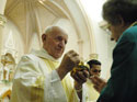 Priest giving out Communion