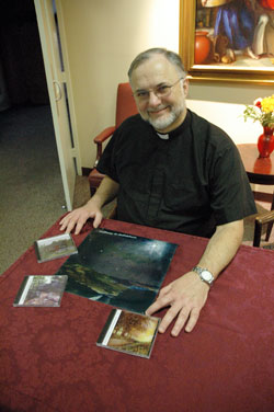 Father James Farrell, the director of Our Lady of Fatima Retreat House in Indianapolis, poses for a photograph on Dec. 2 with his “Pathways to Prayer” series of guided meditation CDs. (Photo by Mary Ann Wyand)
