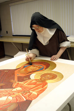 Carmelite Sister Mary Grace Melcher carefully works on a religious icon of Our Lady of Peace holding the Christ Child. Another icon of Mary and the infant Jesus that she created for the millennium has been published by Printery House at the Benedictine Conception Abbey in Conception, Mo. (Submitted photo)