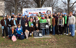 Archdiocesan pilgrims who rode on Bus 2 to the March for Life in Washington pose for a group picture on Jan. 22 with the archdiocesan banner before boarding the bus to return home. (Submitted photo by Josh Shaffner)
