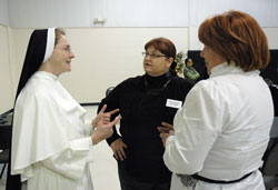 Dominican Sister Mary Michael Fox speaks with Theresa Shaw, center, the administrator of religious education at Holy Family Parish in New Albany, and Connie Sandlin, the director of religious education at St. Anthony of Padua Parish in Clarksville, on Jan. 12 at St. John the Apostle Parish in Bloomington during the winter business meeting for archdiocesan parish administrators of religious education. (Photo by Sean Gallagher)
