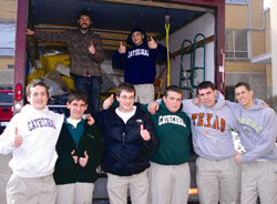 The Cathedral High School family was more than happy recently to gather donations for refugee families being resettled in the archdiocese through Catholic Charities Indianapolis. Shown packing a Catholic Charities’ truck with donated goods, are, front row, from left, John White, Jack Christ, Ryan Thie, Levi Kinney, Jacob Robinson and Michael Cohoat. Standing in the truck are, left, Tim Winn, donations volunteer coordinator for Catholic Charities’ Refugee Resettlement program, and Michael Venezia. (Submitted photo)