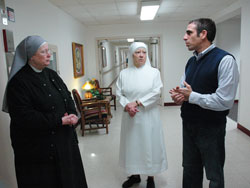Bobby Schindler, right, talks with Little Sisters of the Poor Judith Meredith, left, and Elizabeth Kleibusch during a Feb. 12 visit to the St. Augustine Home for the Aged in Indianapolis. He is the younger brother of the late Terri Schindler Schiavo, and the director of Terri’s Foundation, which helps families protect their relatives who have suffered brain damage. (Photo by Mary Ann Wyand)