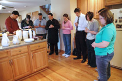 Young adults from New Albany Deanery parishes pray with Father Eric Augenstein, center, the pastor of Our Lady of Perpetual Help Parish in New Albany, during a “Pasta with the Pastor” gathering on March 26 at the parish rectory. He is 32. (Photo by Mary Ann Wyand)