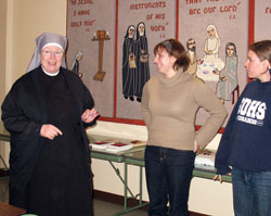 Sister Judith Meredith, left, the superior of the Little Sisters of the Poor in Indianapolis, speaks with Theresa Mills and Annie Girresch about her religious community on Feb. 27 at the order’s St. Augustine Home for the Aged in Indianapolis. The visit was part of a “nun run” in which Mills, Girresch and three other women visited members of seven religious communities in Beech Grove and Indianapolis. The nun run was organized by the communities as a way to promote religious vocations. (Submitted photo)