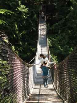 St. Luke the Evangelist parishioners Gabriella Benko, 12, and Matthias Benko, 8, of Indianapolis navigate one of Lynn Canyon Park’s famous suspension bridges. The swaying bridge hangs 20 stories above Lynn Creek. Children love it. (Photo by Kamilla Benko)