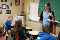 Jennifer Prickel teaches a seventh-grade religion class on March 10 at St. Nicholas School in Ripley County. Prickle, who desires to enter the Steubenville, Ohio-based Sisters of Reparation to the Most Sacred Heart of Jesus, is being held back from responding to her vocation to religious life by student loan debt. (Photo by Sean Gallagher)