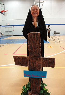 Fourth-grader Molly Habegger of Indianapolis poses as St. Theodore Guérin at the conclusion of St. Luke School’s fourth annual fundraiser to benefit the Food Link, a poverty relief ministry in Marion County, on May 26. The students researched noteworthy people with past or present connections to Indiana then dressed in elaborate costumes and presented memorized speeches about their lives. (Photo by Mary Ann Wyand)