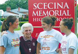 Franciscan Sister Lavonne Long’s love of interacting with young people shines on her face. In this 2006 file photo, the then 84-year-old educator shares a laugh with, from left, Hannah Zimmerman, Jesse Wilson and Jessi Wright, students at Father Thomas Scecina Memorial High School in Indianapolis. (File photo by John Shaughnessy)